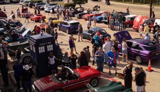 Several classic British cars in front of British Emporium.